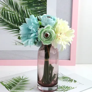 Pastel artificial silk flower bouquet with gerberas and roses in a purple glass vase for decor