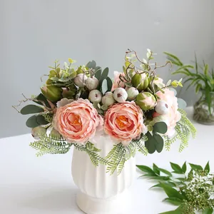 Detailed view of artificial pink peony bouquet in a white textured ceramic vase