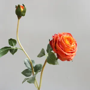 Macro detail of artificial silk rose with realistic burned edges and orange gradient