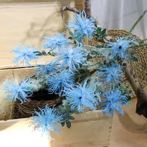 Close-up of sky blue flocked artificial sea urchin flowers in a rustic wooden setting