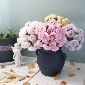 Detailed view of 27-head artificial tea rose bouquets in a black ceramic vase