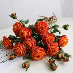 Detailed view of burnt orange artificial silk roses featuring realistic charred edge petals