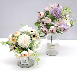 Detailed view of Nordic style artificial flower bouquets in clear glass vases