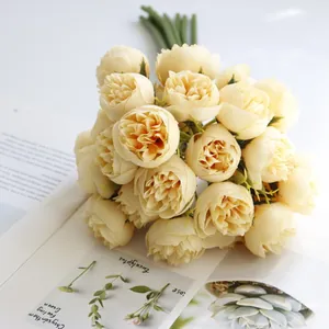 Macro detail of a 27-head artificial tea rose bouquet in cream color for home decoration