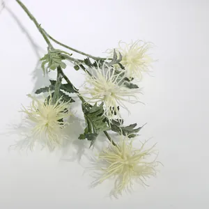 Close-up detail of white flocked artificial sea urchin flowers for wedding decor.