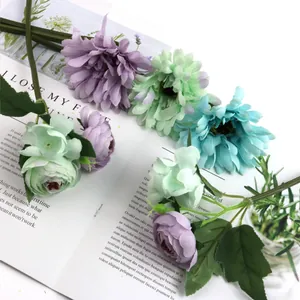 Close-up of colorful artificial Gerbera and rose bouquet on magazine background