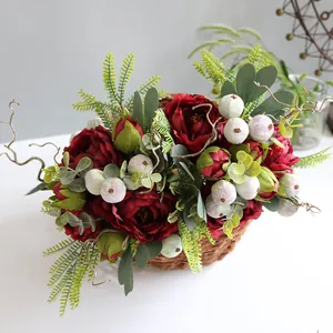 Dark red artificial peony flower arrangement in rustic wicker basket for home decor