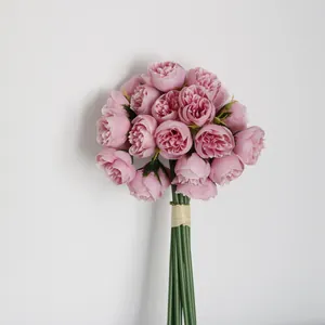Macro view of a 27-head pink artificial tea rose bouquet with realistic green stems