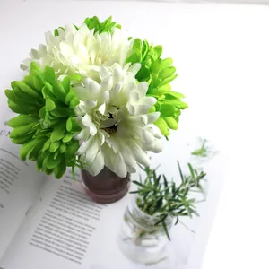 Close-up view of fresh white and green artificial gerbera daisy flower bouquet for home decoration