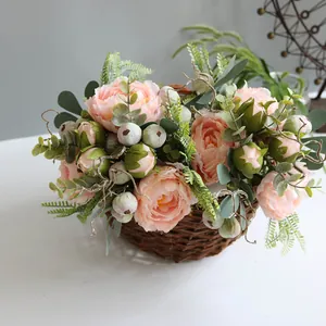Close-up of pink artificial Penglai peonies arranged in a woven basket for home decor.