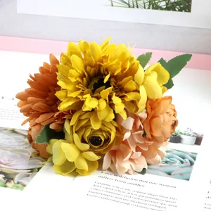 Detailed view of yellow and orange artificial Gerbera and rose bouquet texture.