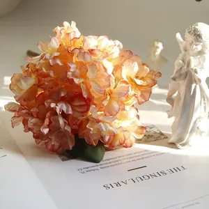 Retro coral artificial hydrangea flower with burnt edges for home decor details.