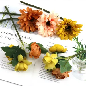 Detailed macro view of lifelike artificial gerberas and fabric roses for home decor.