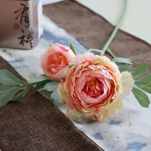 Detail of two-head artificial ranunculus silk flowers in soft pink for home decor