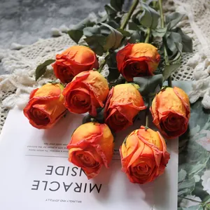Detailed view of artificial orange roses with realistic burnt edges for decor
