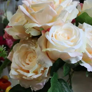 Close-up detail of artificial cream roses with curled pink edges for home decor