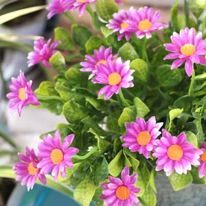 Close-up detail of vibrant purple artificial chamomile daisy bouquet for balcony decor