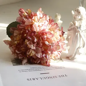 Detailed view of French vintage coral artificial hydrangea with realistic burnt edges