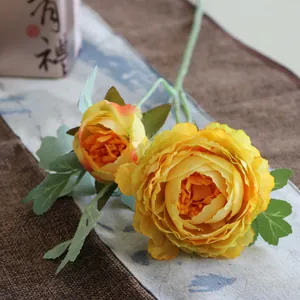 Detailed macro view of two-head yellow artificial Ranunculus silk flower petals