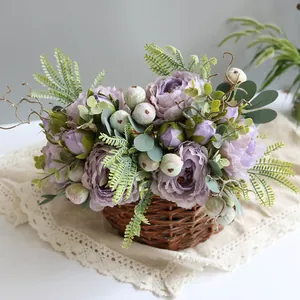 Detail view of purple artificial peony arrangement in a rustic wicker basket