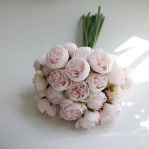 Macro view of a 27-head pale pink artificial tea rose bouquet for wedding decor.