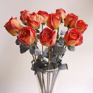 Detail view of artificial burnt-edge silk roses in a vase for home and Halloween decor
