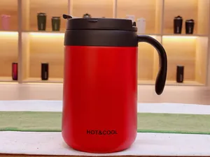 Macro view of a red 304 stainless steel insulated coffee mug with handle and lid