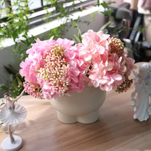Elegant artificial pink hydrangea silk flowers in a vase for home table decoration