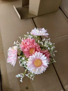 Detailed top view of decorative pink and white artificial daisy flowers in a black pot