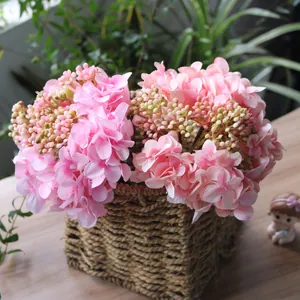 Macro detail of artificial pink silk hydrangea and carnation bouquet in a basket