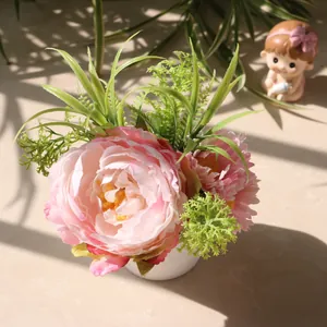 Macro detail of artificial pink peony and daisy potted plant in natural window sunlight