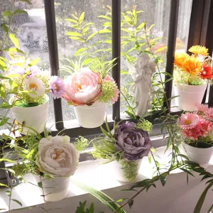 Vibrant peony and daisy artificial potted plants in a sunny window display