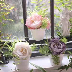 Vibrant pink, white and purple artificial peony potted plants on a window sill scene