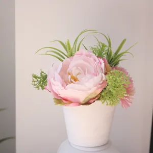 Close-up of elegant pink peony and daisy simulation potted plant in minimalist white vase