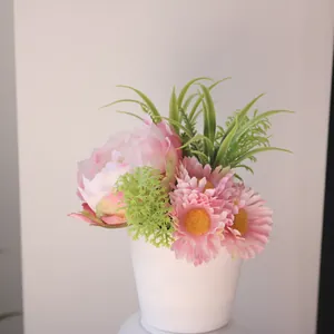 Detailed view of realistic artificial pink peony and daisy flowers in a white pot