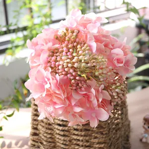 Detailed macro view of pink artificial hydrangea flowers in a rustic woven basket