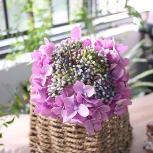 Detailed macro shot of artificial purple hydrangea silk flowers in a rustic woven basket