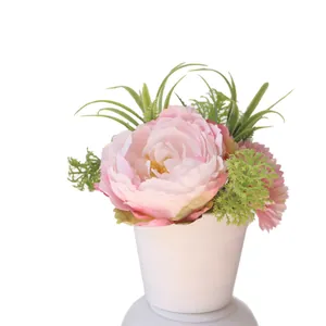 Artificial pink peony and daisy flowers in white pot for home tabletop decoration