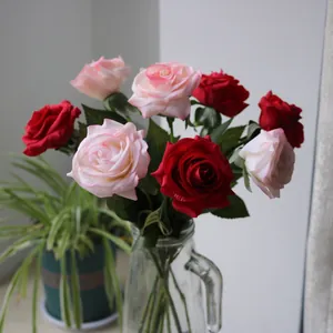 Lifelike red and pink silk roses in a clear glass vase for elegant home decor setup