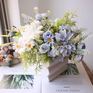 Close-up of silk dahlia, rose and daisy artificial flower arrangement in white vase