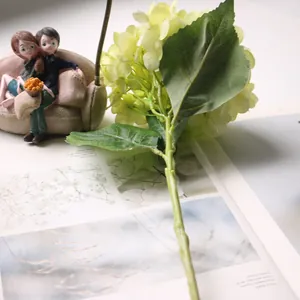 Detailed view of artificial hydrangea stem with realistic green petals and leaves