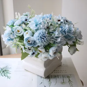 Detailed view of a light blue artificial tea rose and hydrangea bouquet in a white vase