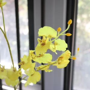 Close-up of vibrant yellow artificial Oncidium orchid flowers with delicate petal details