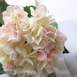 Macro detail of artificial hydrangea flower head with soft pink and cream petals for wedding decor