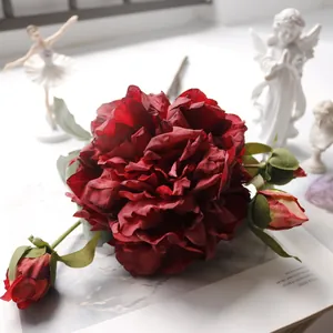 Close-up of elegant artificial red peony bouquet with realistic silk petals for home decor