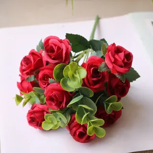 Close-up detail of artificial red rose bouquet with lush green eucalyptus leaves for decor