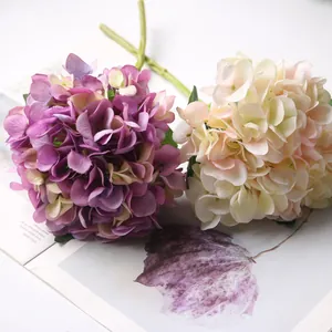Close-up of artificial hydrangea flower heads in purple and creamy pink for home decor.
