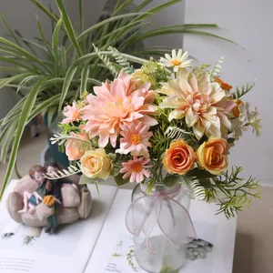 Close-up of dahlia, rose, and daisy silk flower arrangement in a glass vase decor