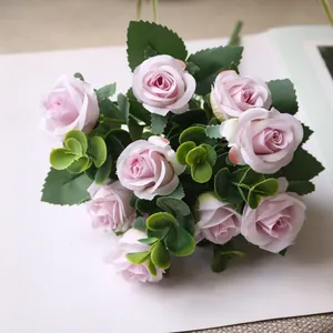 Macro detail of artificial pink rose bouquet with eucalyptus leaves for wedding decor