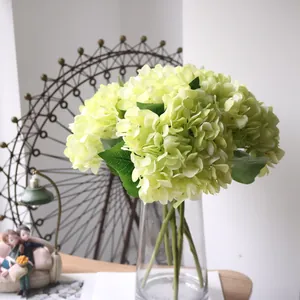 Realistic light green artificial hydrangea bouquet in a clear glass vase for home decor